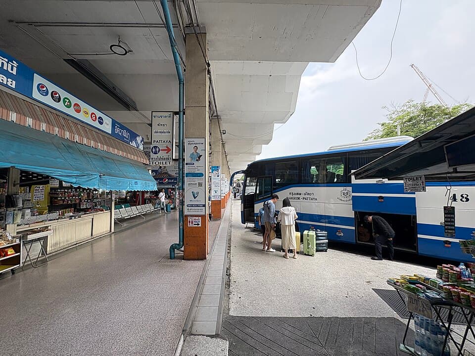 Inside area of Ekkamai Bus Terminal with counters and signs near the boarding lanes.